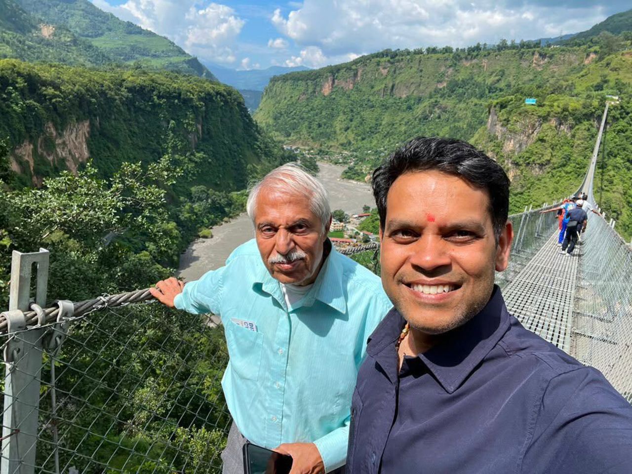 Vivek Shankar Srivastav is seen with another travel group member before the flooding occurred.