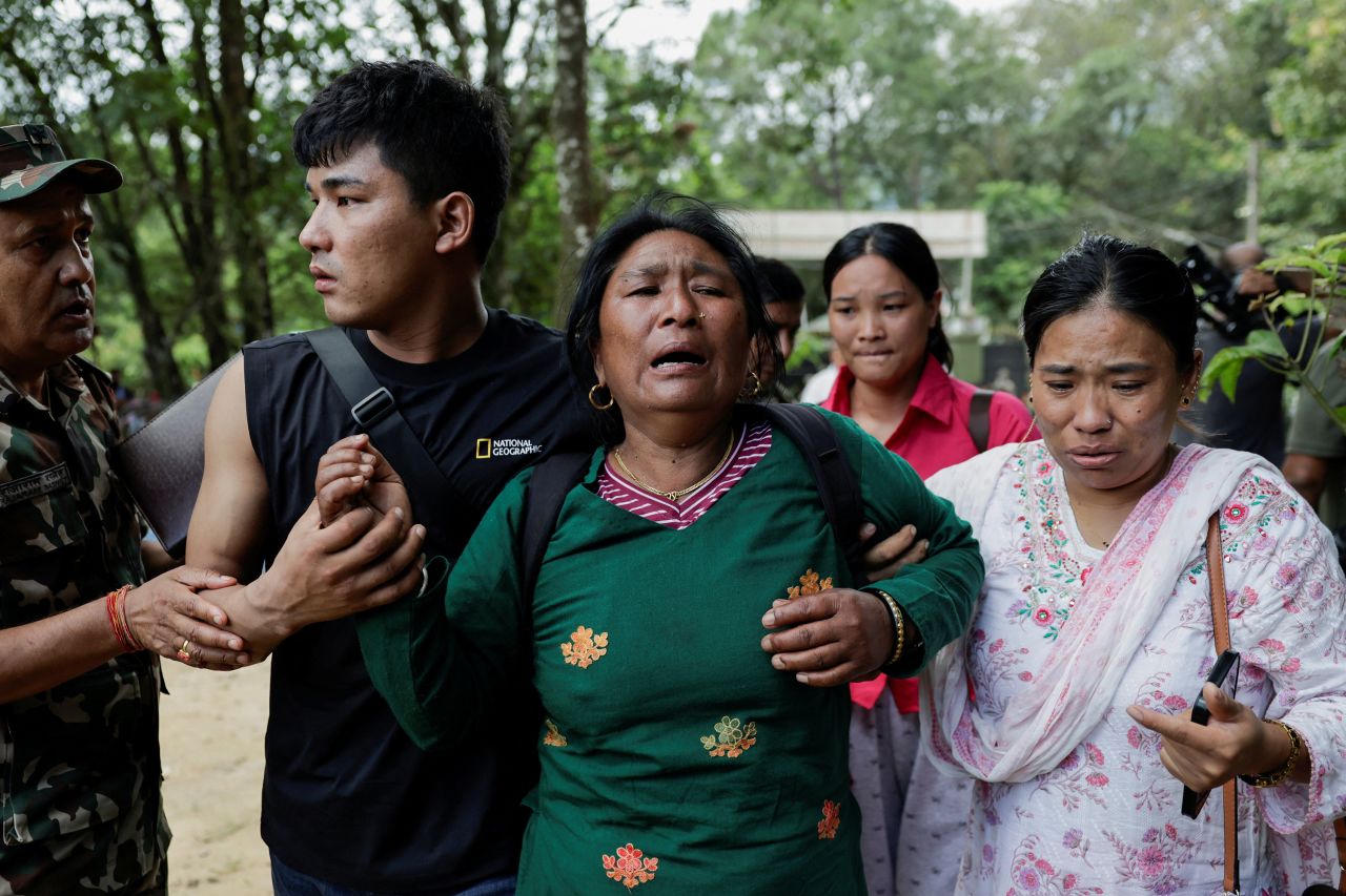 A woman affected by flash floods and mudslide, arrives at the Maithali Barrack, an army training center, at Trishuli in Nuwakot district, Nepal, August 28.