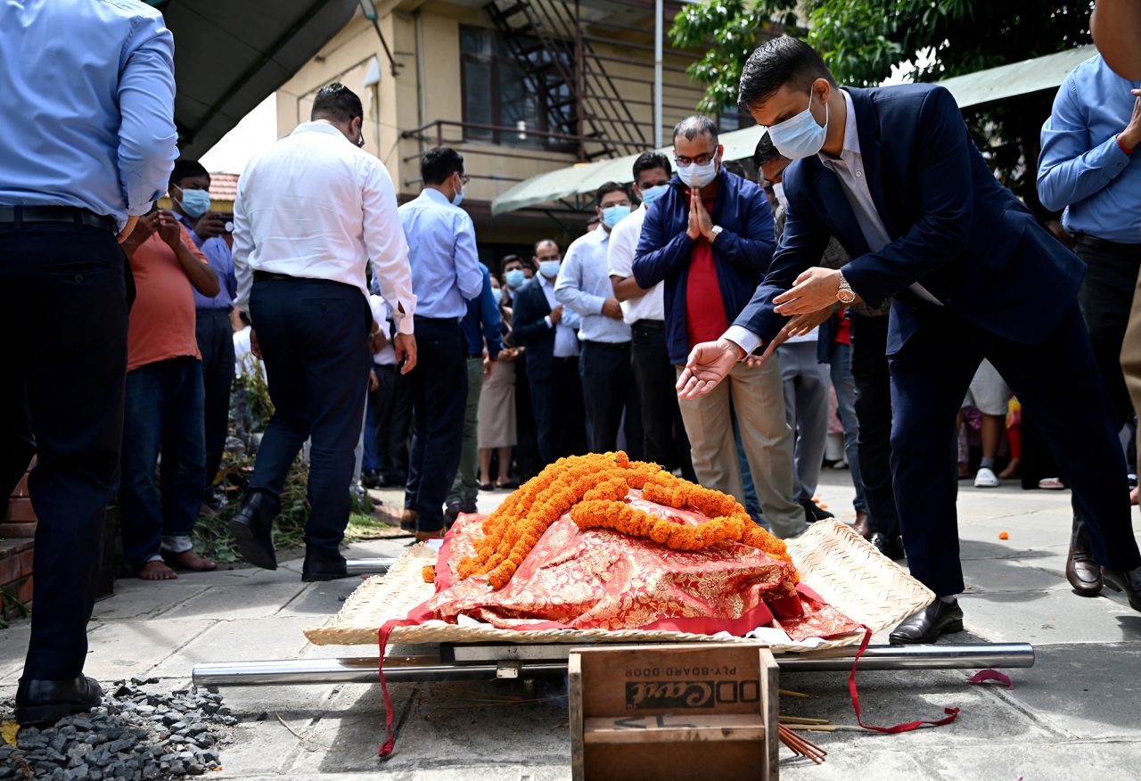 People pay their respects to the body of flood victim Sundari Shrestha, 41, at a crematorium in Kathmandu on Monday.