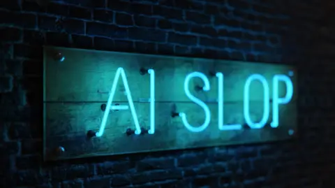 Getty Images Thin blue neon letters fixed to a brick wall read: 'AI SLOP'.