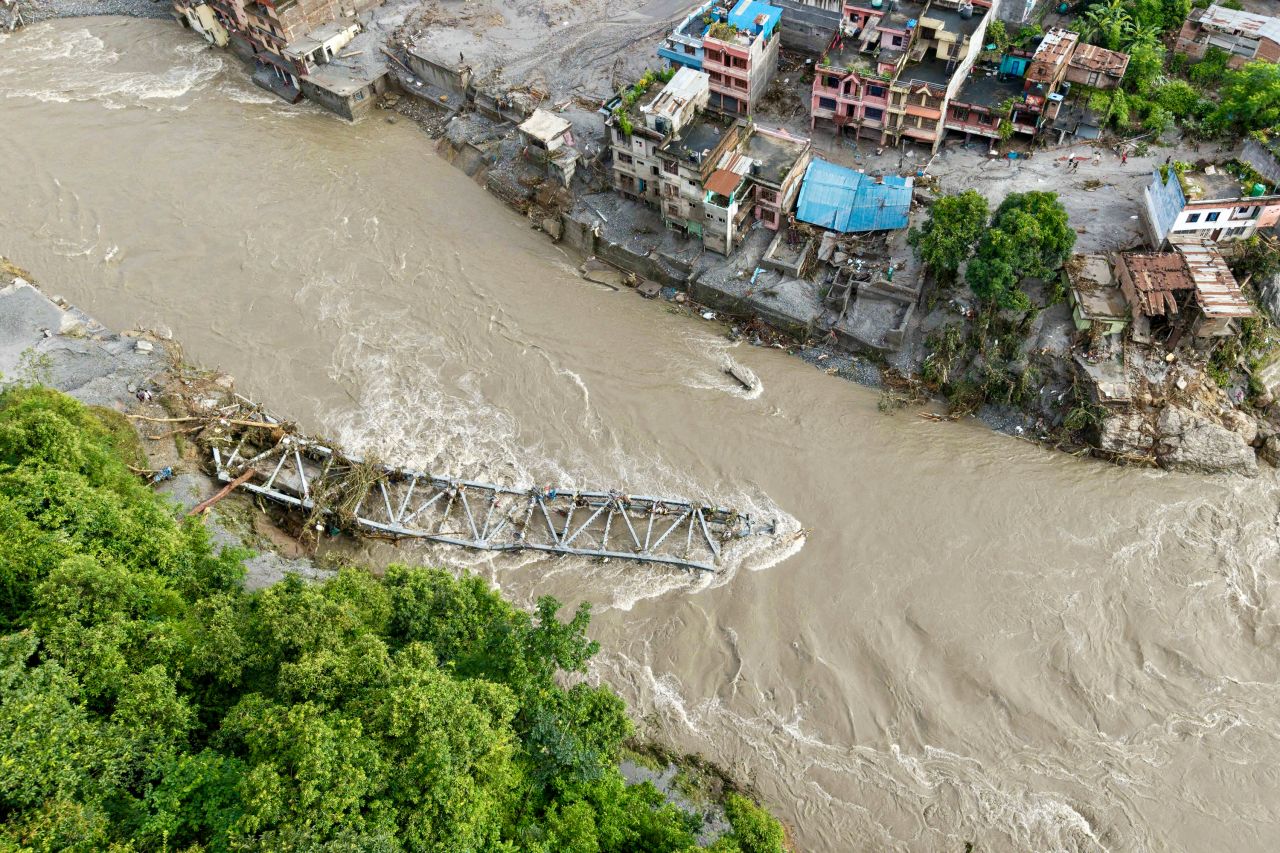 An aerial view shows a collapsed bridge after flash floods at Devighat, Bidur Municipality in Nepal's Nuwakot district on Thursday.