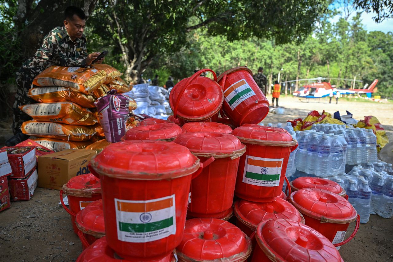 An army official stands beside relief materials that arrived from India, at Trishuli camp in  Nepal on Sunday.
