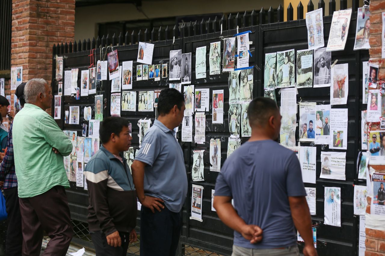 Families and relatives of missing persons from the Tibet-Nepal floods view images of bodies displayed on the walls of the Tribhuvan University Teaching Hospital in Kathmandu, Nepal, on Sunday.