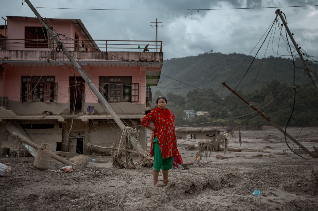 A woman surveys the damage following flash floods on August 29 in Devighat, Nepal. A flood swept through the Bhote Koshi River basin in northern Rasuwa on August 26, damaging settlements and other infrastructure.