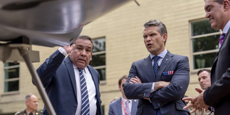 Deputy Assistant Secretary of Defense for Prototyping and Experimentation Alexander Lovett, left, shows a drone to Secretary of Defense Pete Hegseth, center, and Under Secretary of Defense for Research and Engineering Emil Michael, right, at a display of multi-domain autonomous systems in the Pentagon courtyard, Wednesday, July 16, 2025, in Washington.
