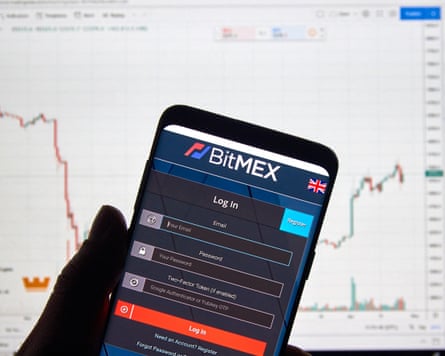 The BitMEX logo on a mobile phone screen with a market chart in the background