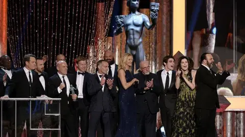 Getty Images Actor Bryan Cranston (C) accepts the Outstanding Performance by an Ensemble in a Drama Series award for 'Breaking Bad' onstage during the 20th Annual Screen Actors Guild Awards at The Shrine Auditorium on January 18, 2014 in Los Angeles, California. (Photo by Kevork Djansezian/Getty Images)