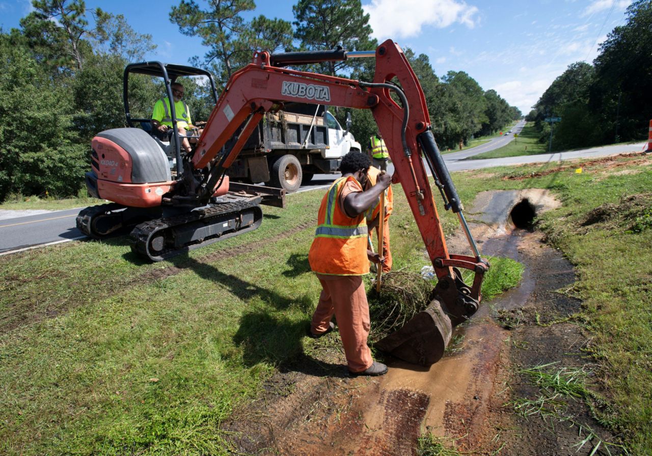 Crews work to clear storm drains in Escambia County, Florida, on October 7.